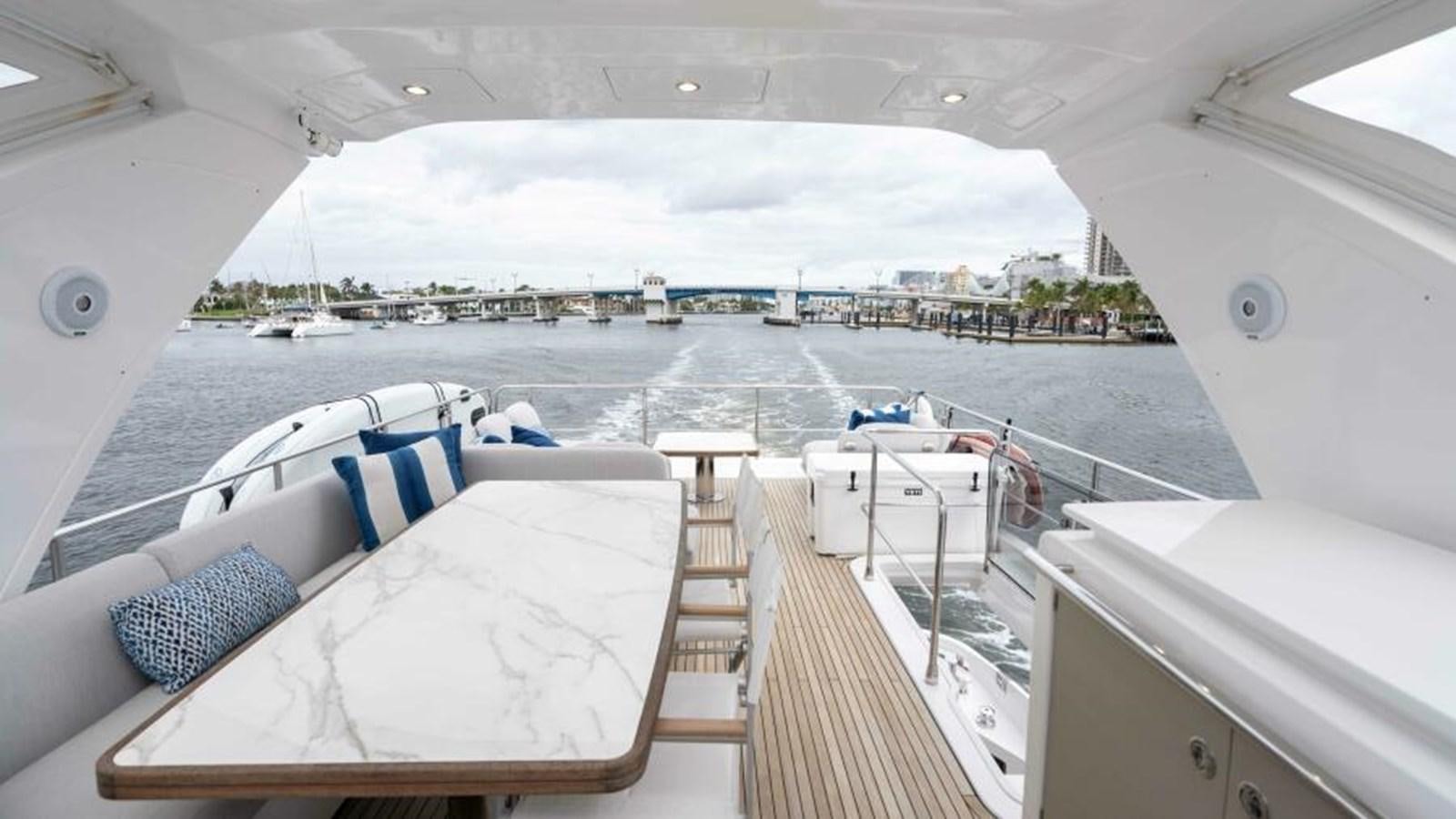 a deck with a view of a city and water aboard LIQUID ASSET Yacht for Sale