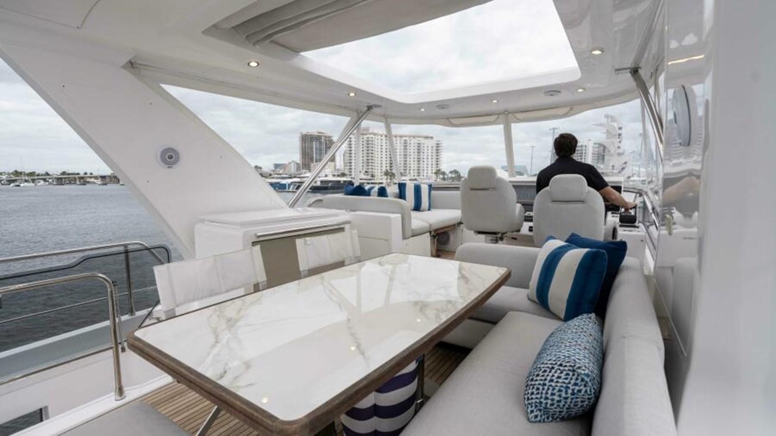 a boat with a table and chairs aboard LIQUID ASSET Yacht for Sale
