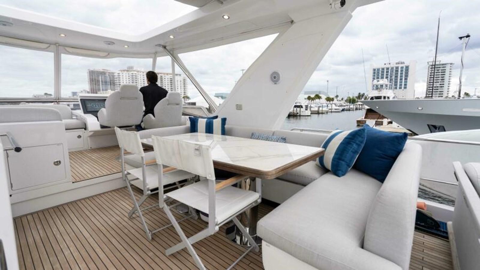 a boat with a table and chairs aboard LIQUID ASSET Yacht for Sale