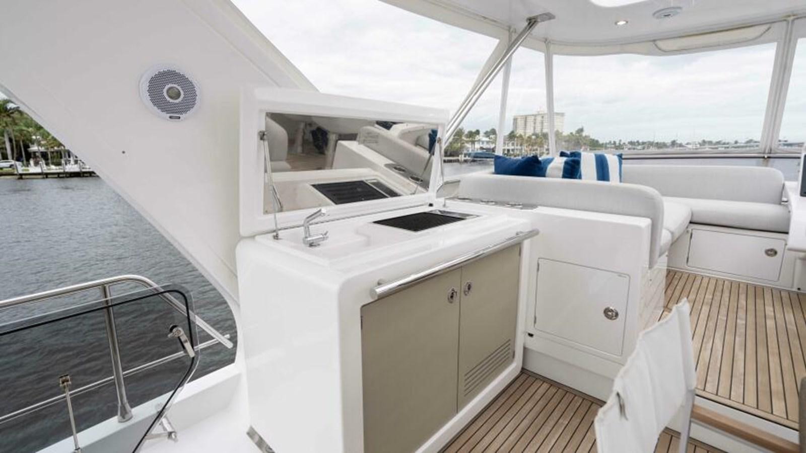 a boat with a sink and a large white cabinet on the deck aboard LIQUID ASSET Yacht for Sale