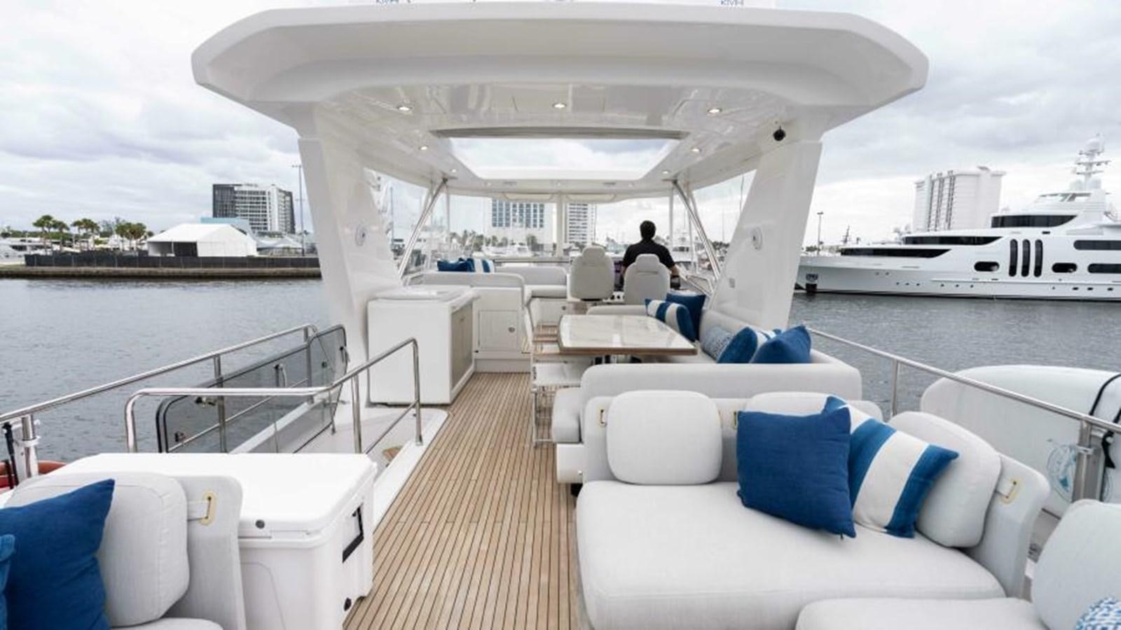 a boat with a large white lounge chair and a large white boat in the water aboard LIQUID ASSET Yacht for Sale