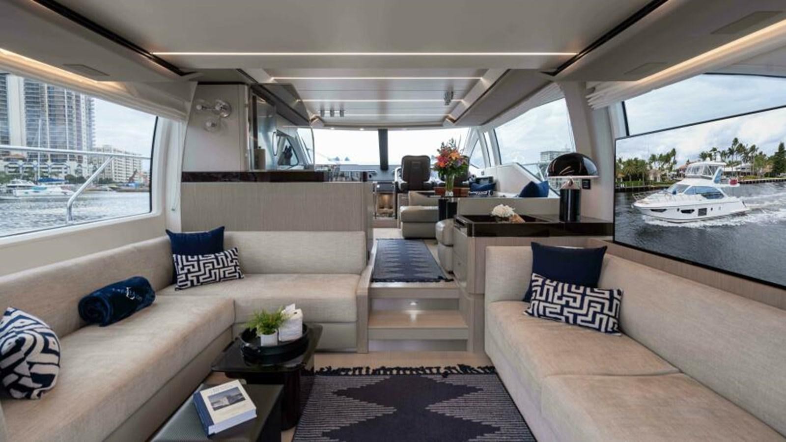 a living room with a couch and a table aboard LIQUID ASSET Yacht for Sale