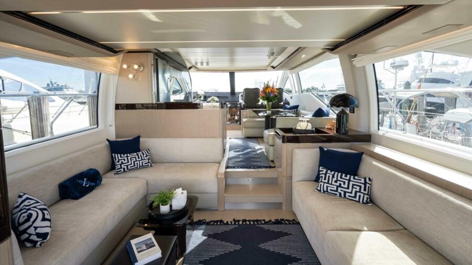 a living room with a couch and a table aboard LIQUID ASSET Yacht for Sale