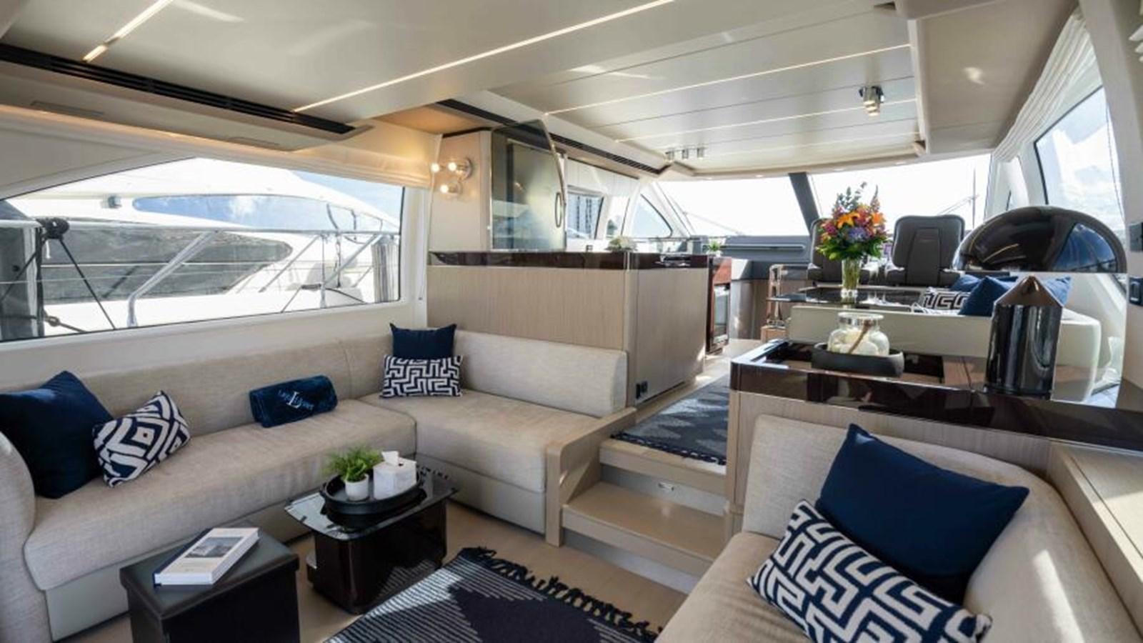 a living room with a couch and a table aboard LIQUID ASSET Yacht for Sale