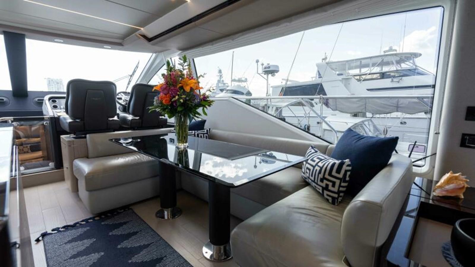 a living room with a large window aboard LIQUID ASSET Yacht for Sale