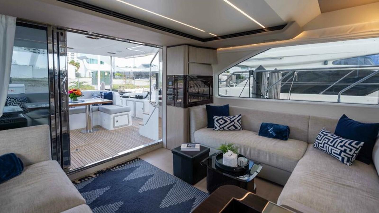 a living room with a large glass door aboard LIQUID ASSET Yacht for Sale