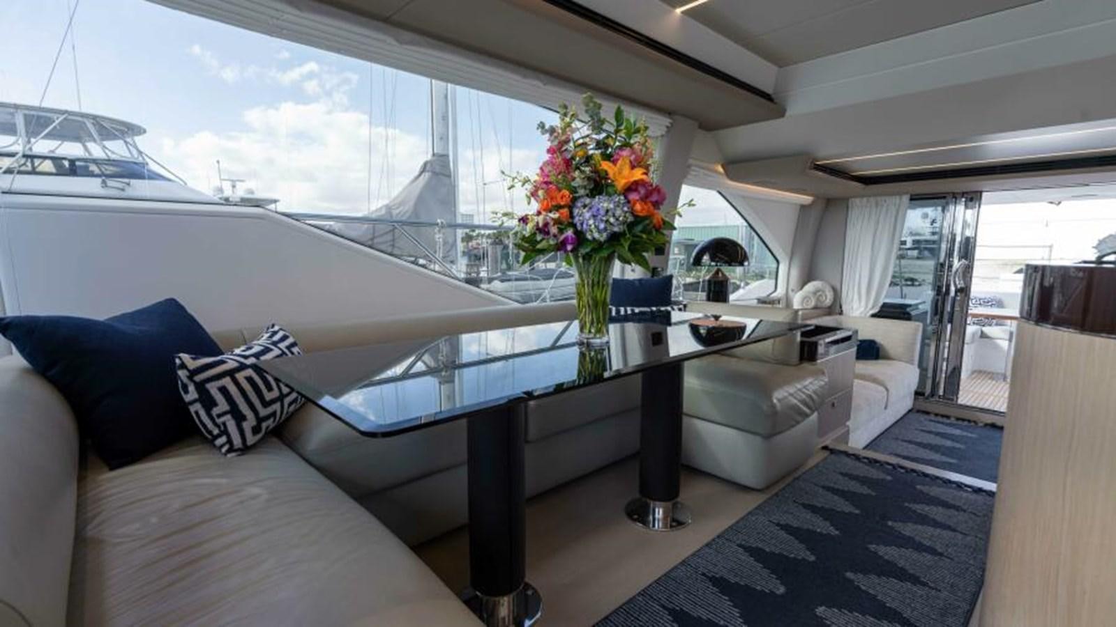 a living room with a large window aboard LIQUID ASSET Yacht for Sale