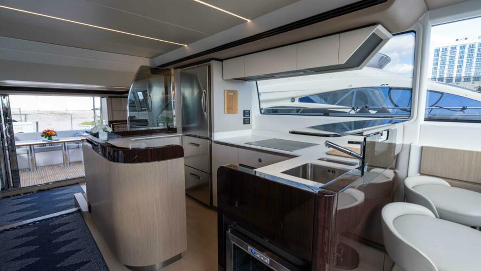 a kitchen with a large window aboard LIQUID ASSET Yacht for Sale