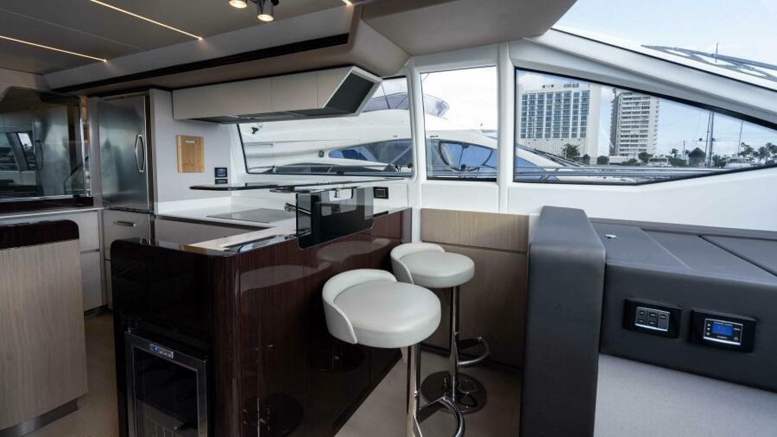 inside of a building with a desk and stools aboard LIQUID ASSET Yacht for Sale