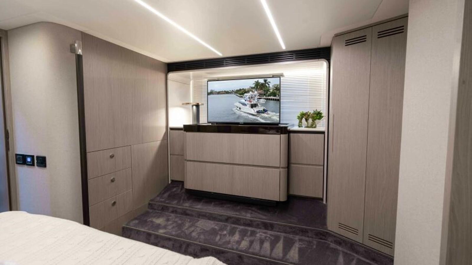 a room with a tv and a bed aboard LIQUID ASSET Yacht for Sale