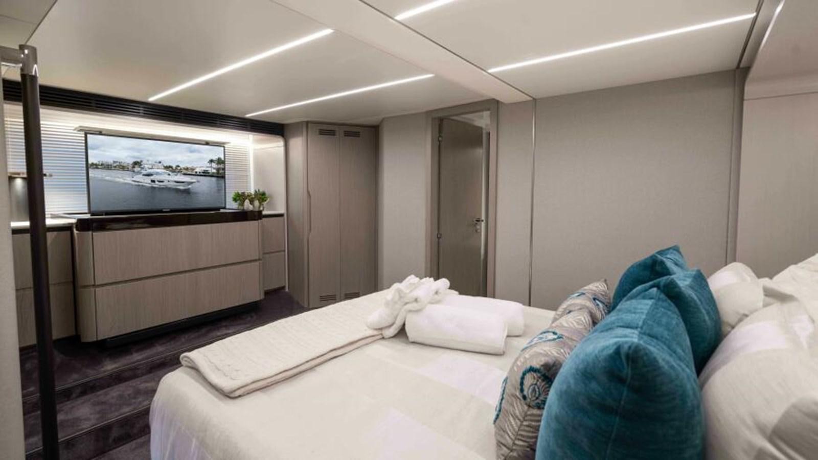 a bedroom with a bed and a tv aboard LIQUID ASSET Yacht for Sale