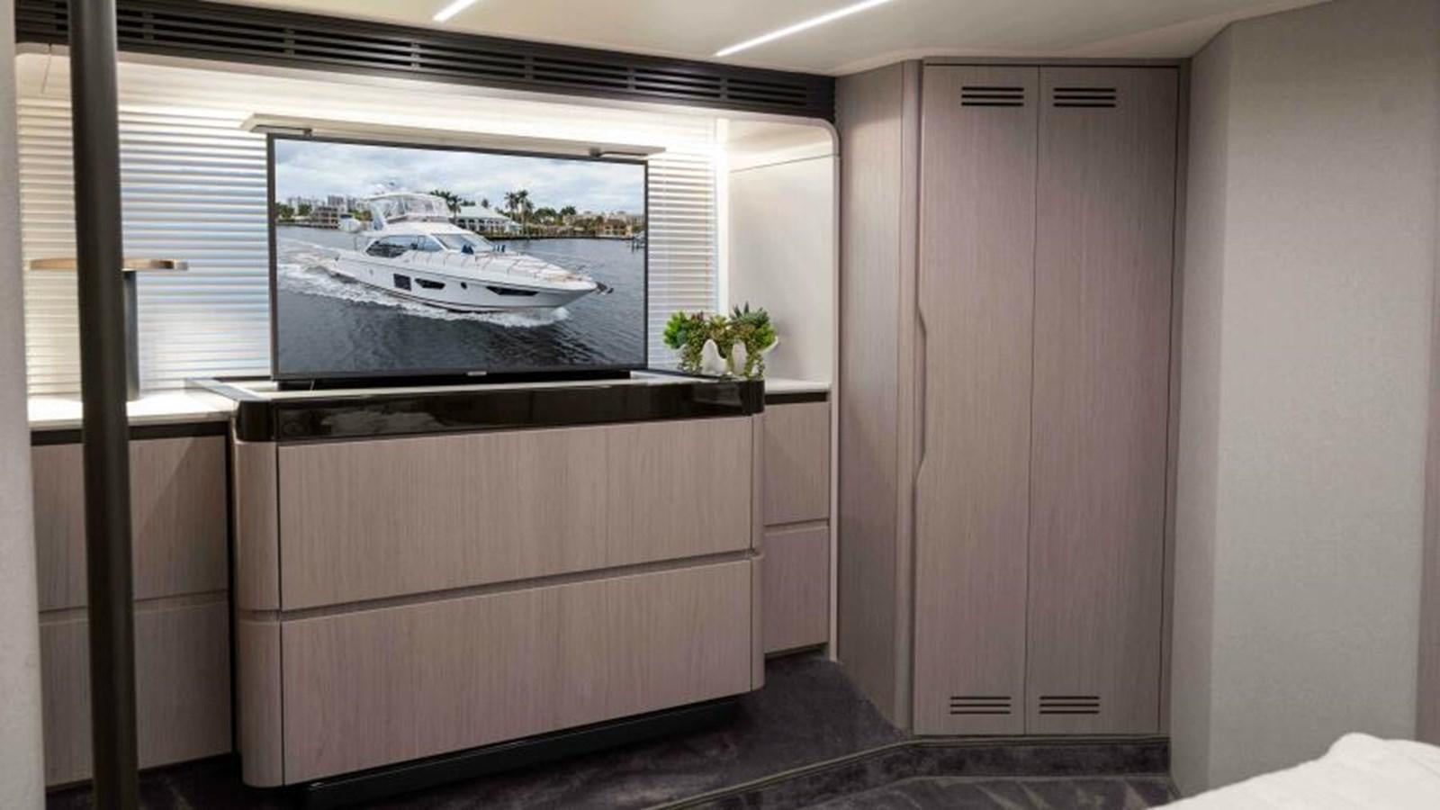a room with a television and a cabinet aboard LIQUID ASSET Yacht for Sale