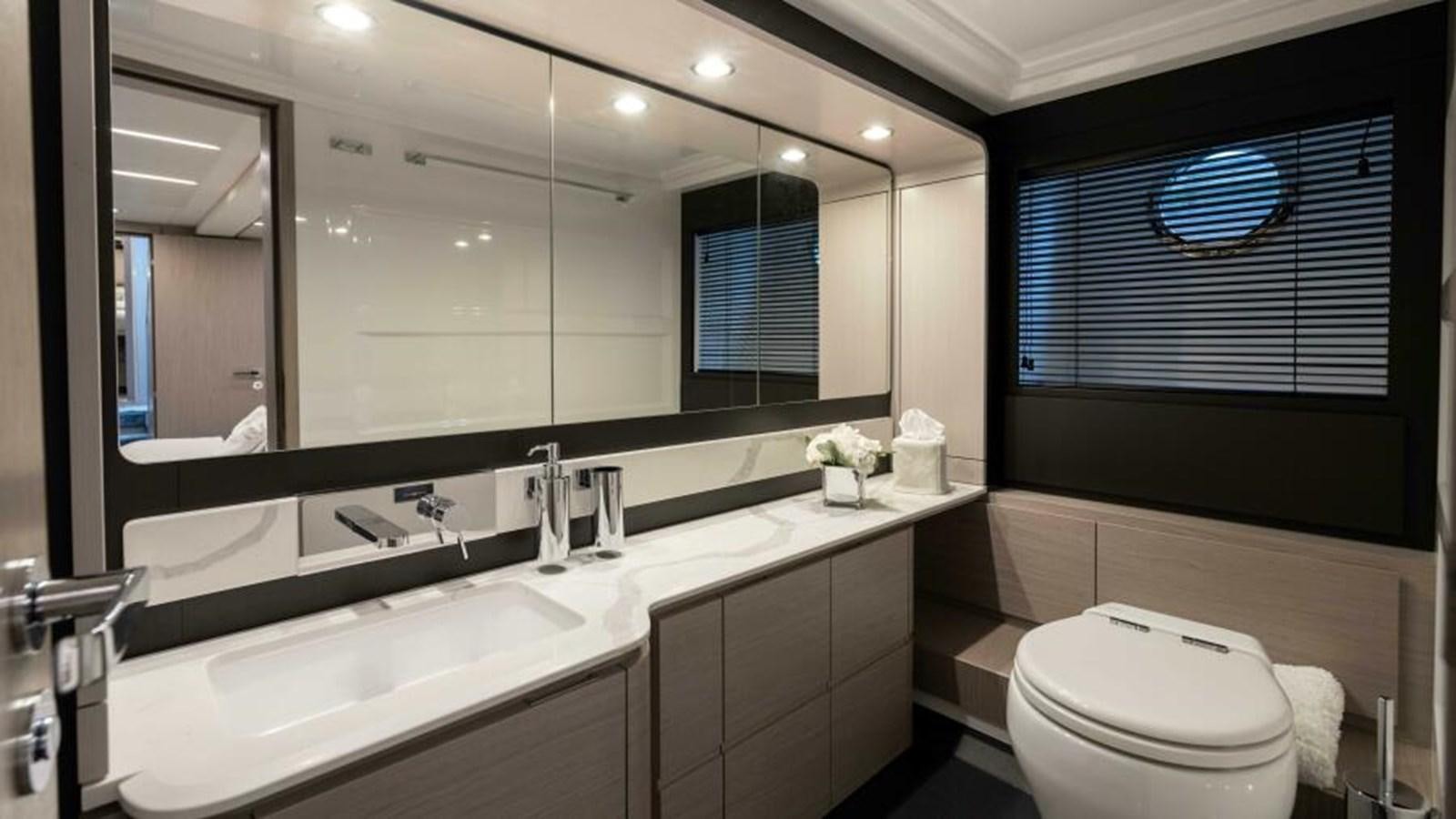 a bathroom with a large mirror aboard LIQUID ASSET Yacht for Sale