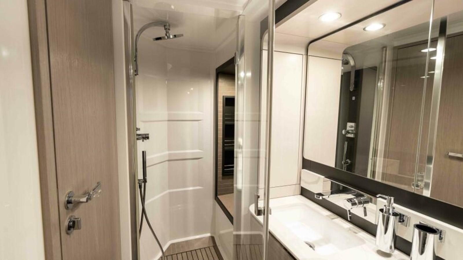 a bathroom with a large mirror aboard LIQUID ASSET Yacht for Sale