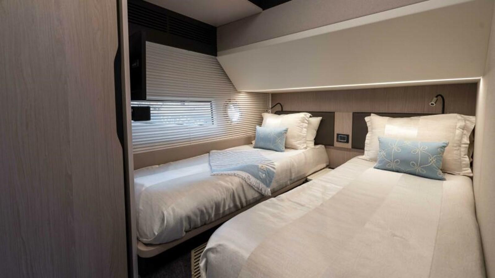 a couple of beds in a room aboard LIQUID ASSET Yacht for Sale