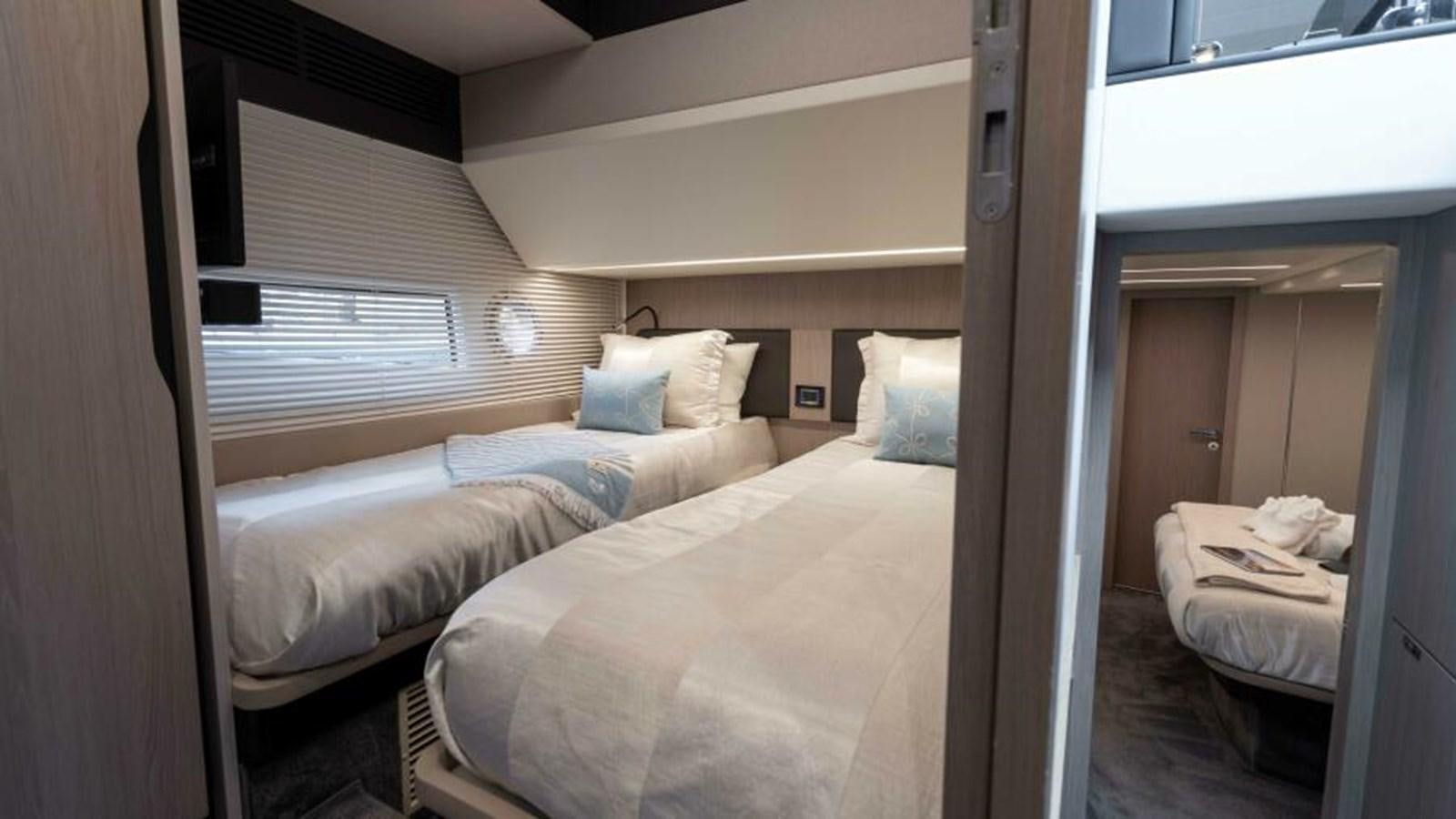 a room with two beds aboard LIQUID ASSET Yacht for Sale