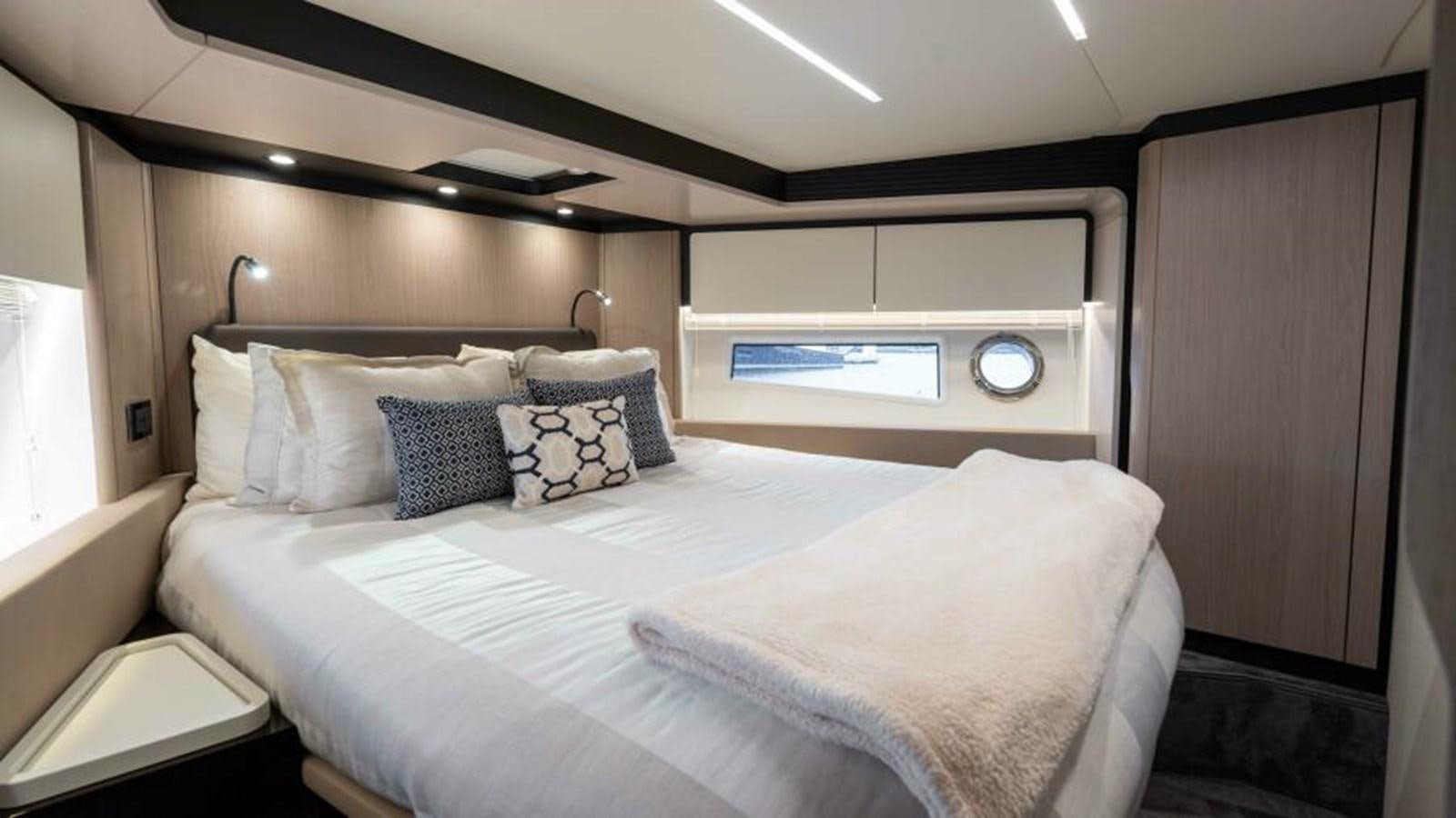 a bed with white sheets aboard LIQUID ASSET Yacht for Sale