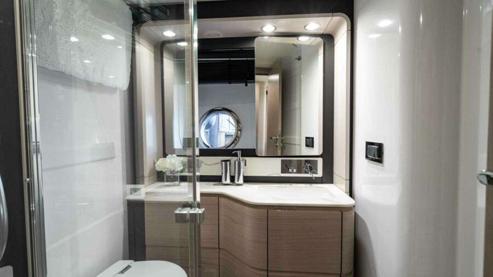 a bathroom with a large mirror aboard LIQUID ASSET Yacht for Sale