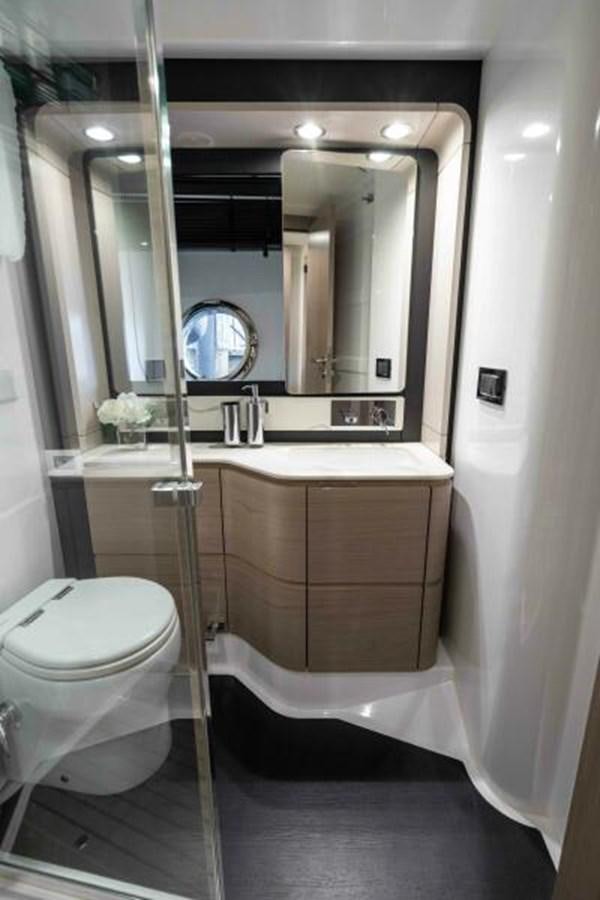 a bathroom with a large mirror aboard LIQUID ASSET Yacht for Sale