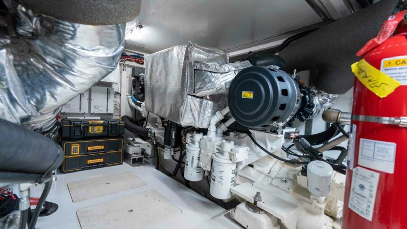 a car with a large black tire aboard LIQUID ASSET Yacht for Sale