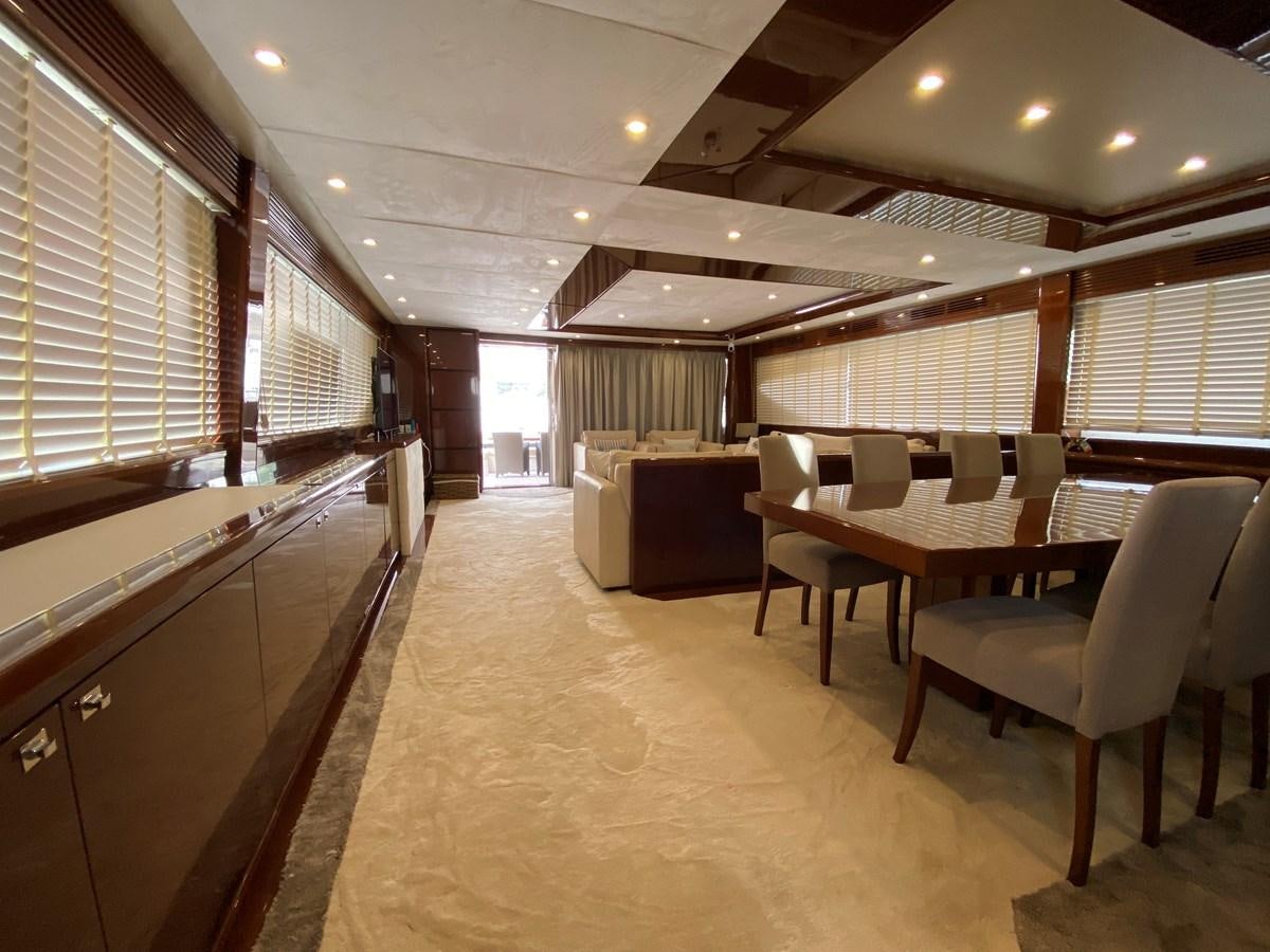 a large room with chairs and a table aboard 95 MY Yacht for Sale