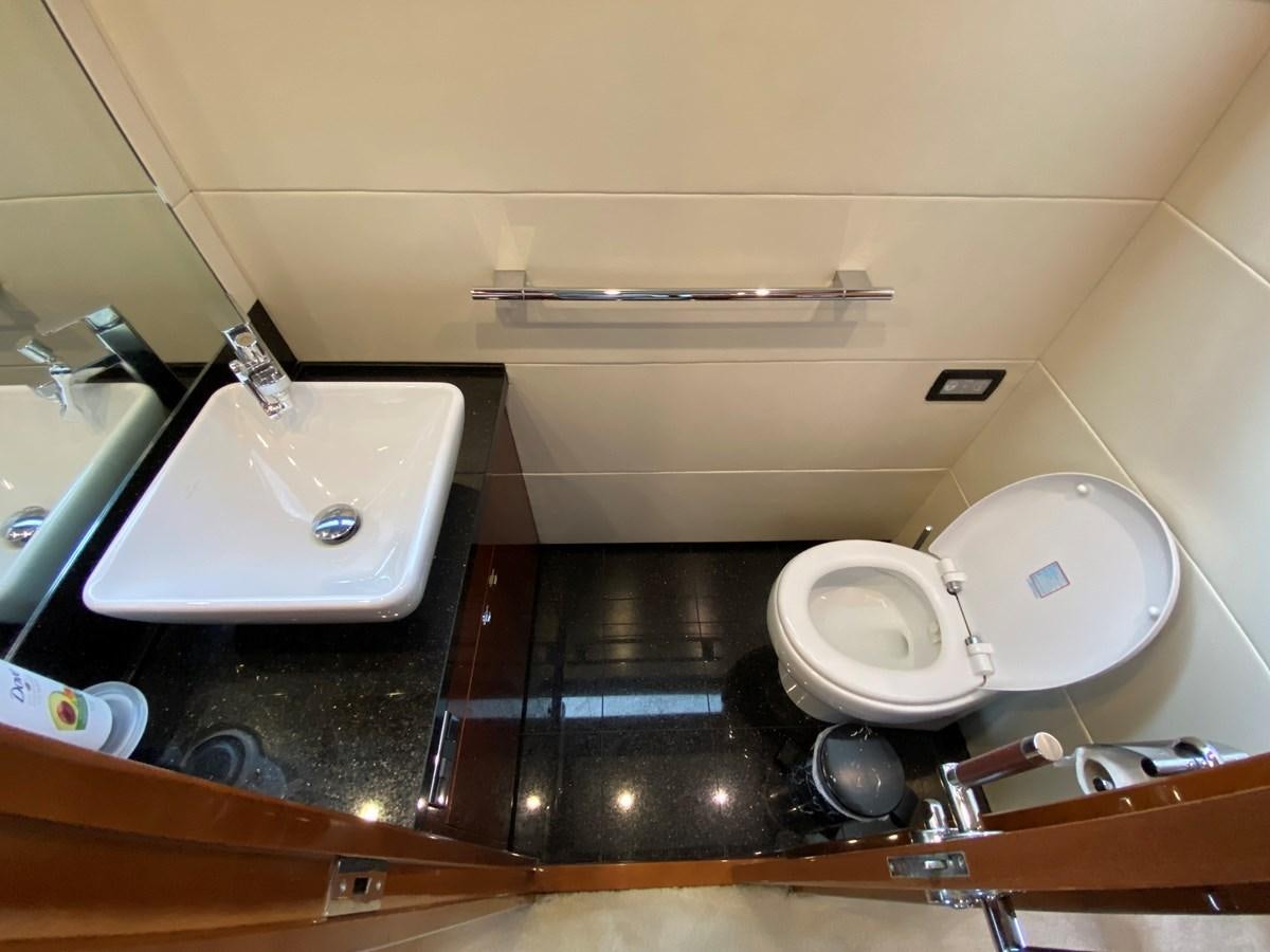 a bathroom with a toilet and sink aboard 95 MY Yacht for Sale