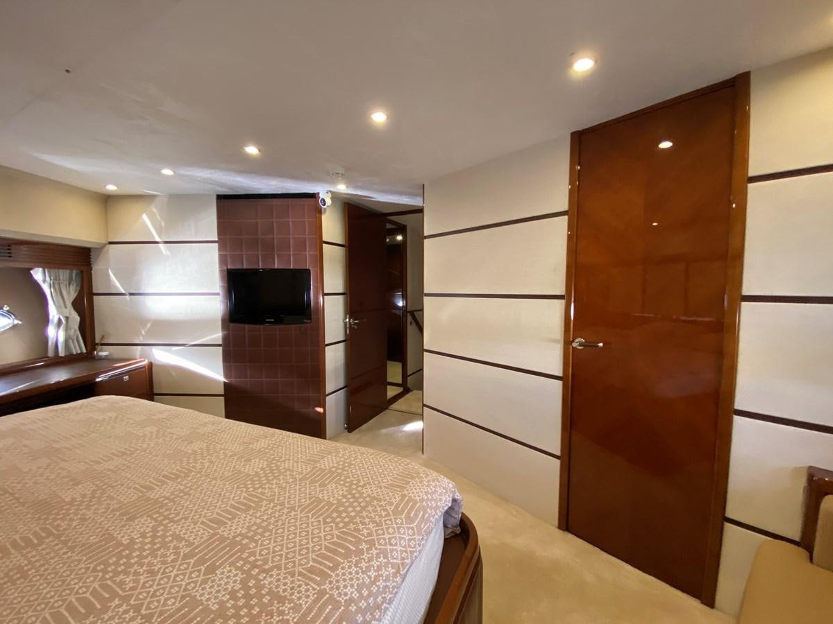 a bedroom with a bed and a closet aboard 95 MY Yacht for Sale
