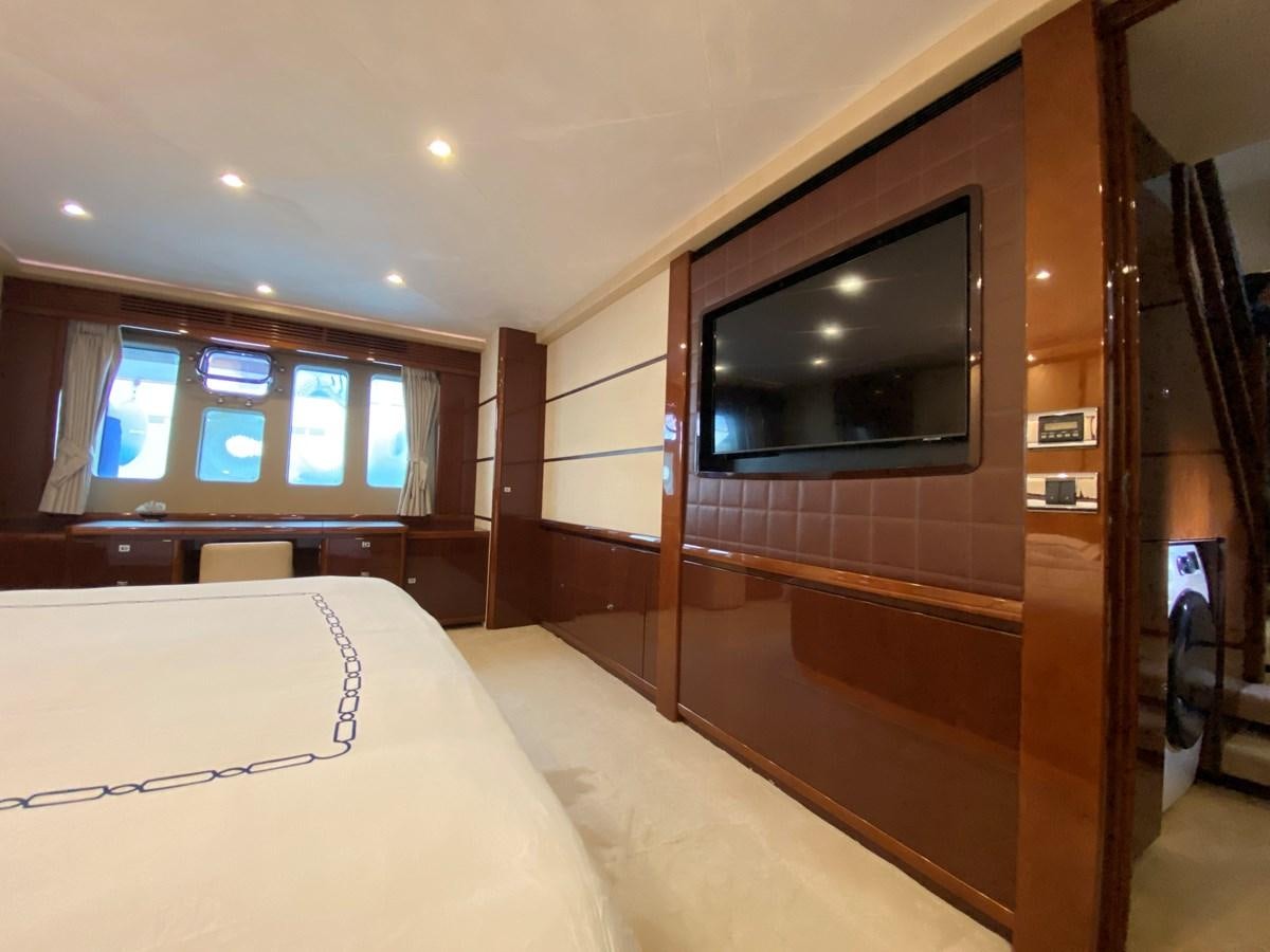 a room with a bed and a tv aboard 95 MY Yacht for Sale