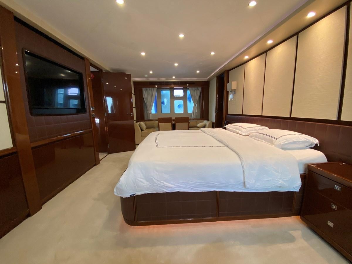 a bedroom with a bed and a tv aboard 95 MY Yacht for Sale