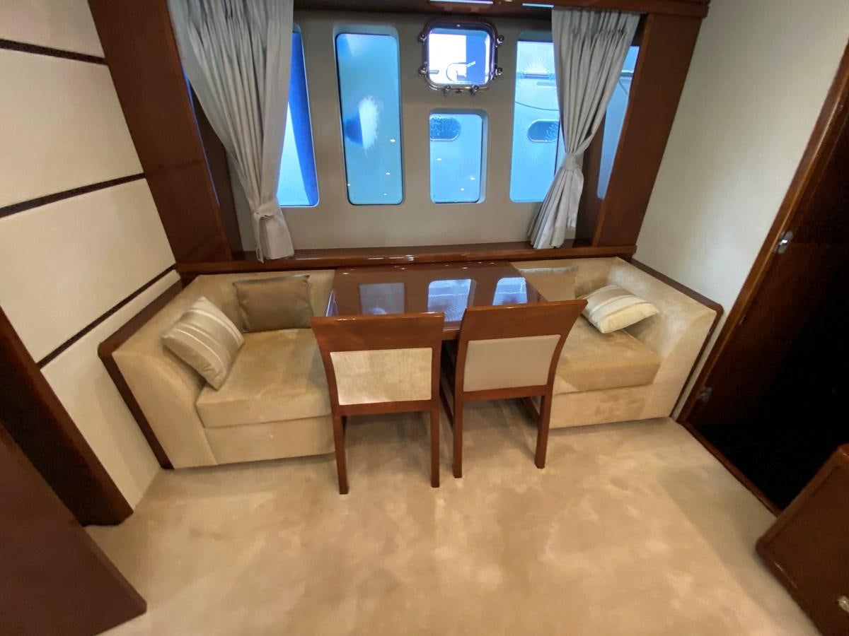 a room with a couch and a table aboard 95 MY Yacht for Sale