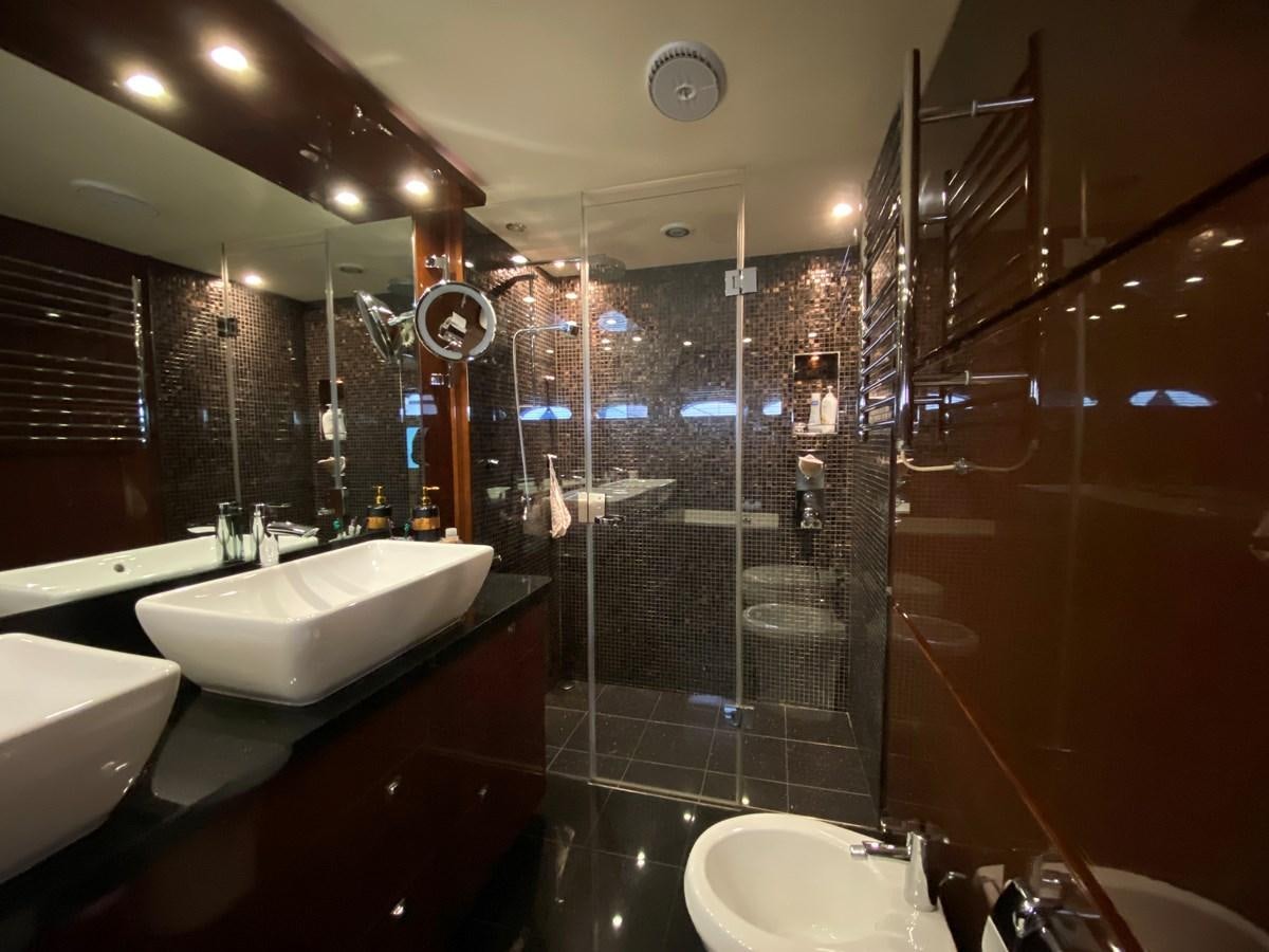 a bathroom with a glass shower aboard 95 MY Yacht for Sale