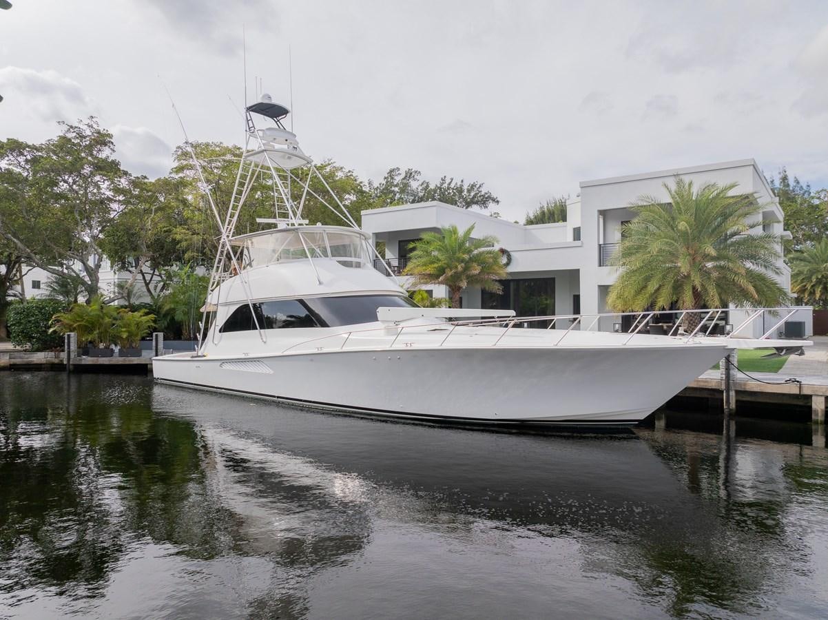 a white boat in a body of water aboard STABILIZED Yacht for Sale