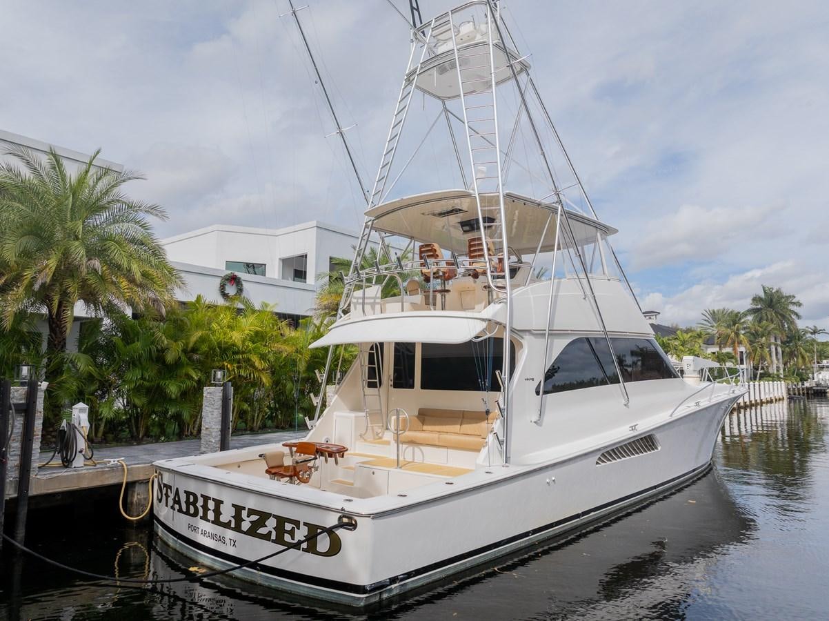 a white boat docked aboard STABILIZED Yacht for Sale