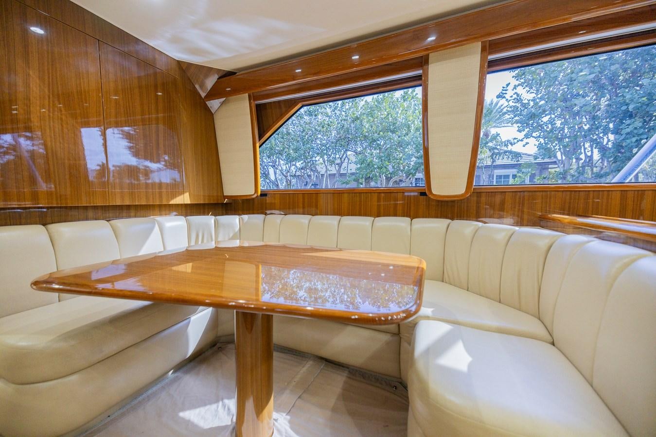 a room with a table and couch aboard STABILIZED Yacht for Sale
