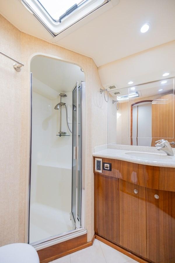 a bathroom with a shower unit and sink aboard STABILIZED Yacht for Sale