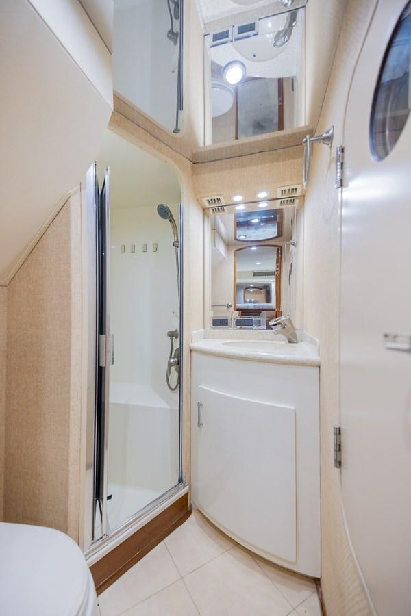 a bathroom with a shower unit and sink aboard STABILIZED Yacht for Sale