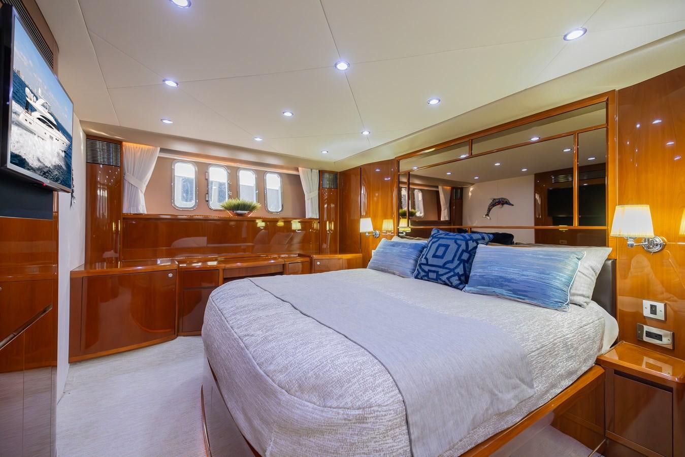 a bedroom with a bed and a television aboard ODYSSEA Yacht for Sale
