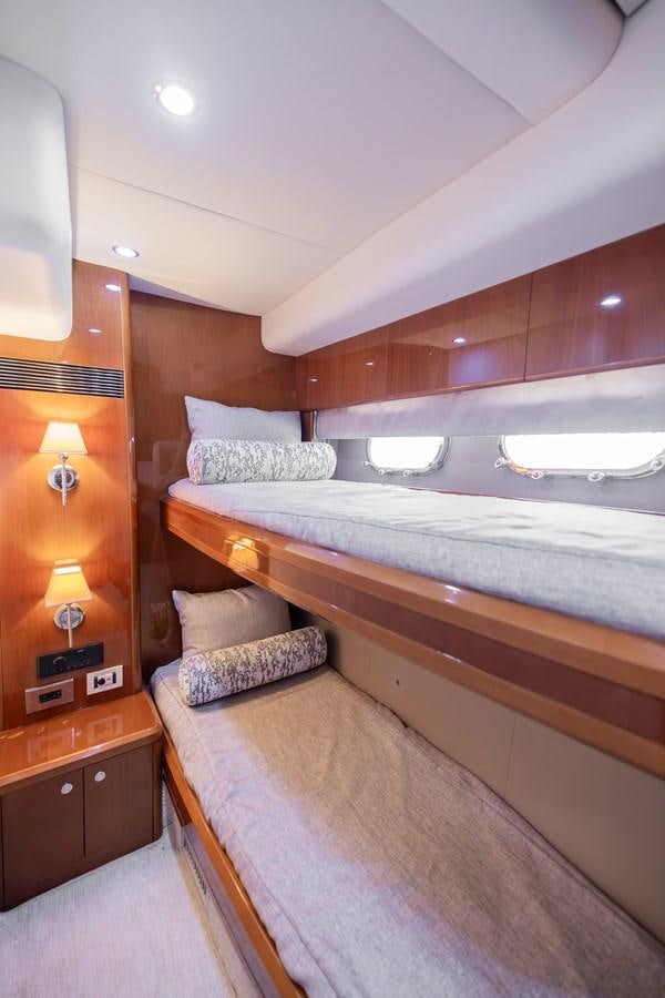 a bed with a wood headboard aboard ODYSSEA Yacht for Sale