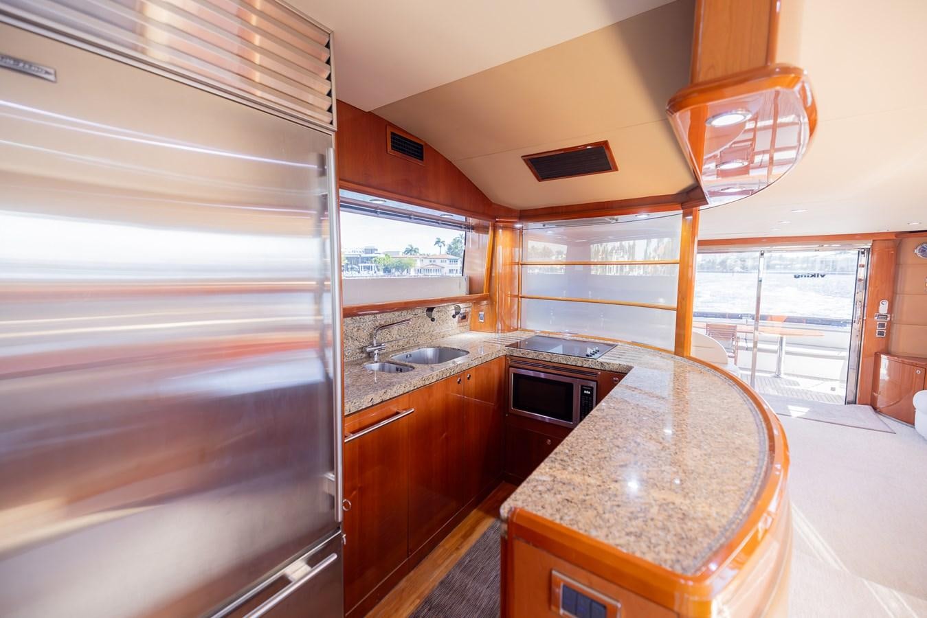 a kitchen with a countertop sink and cabinets aboard ODYSSEA Yacht for Sale