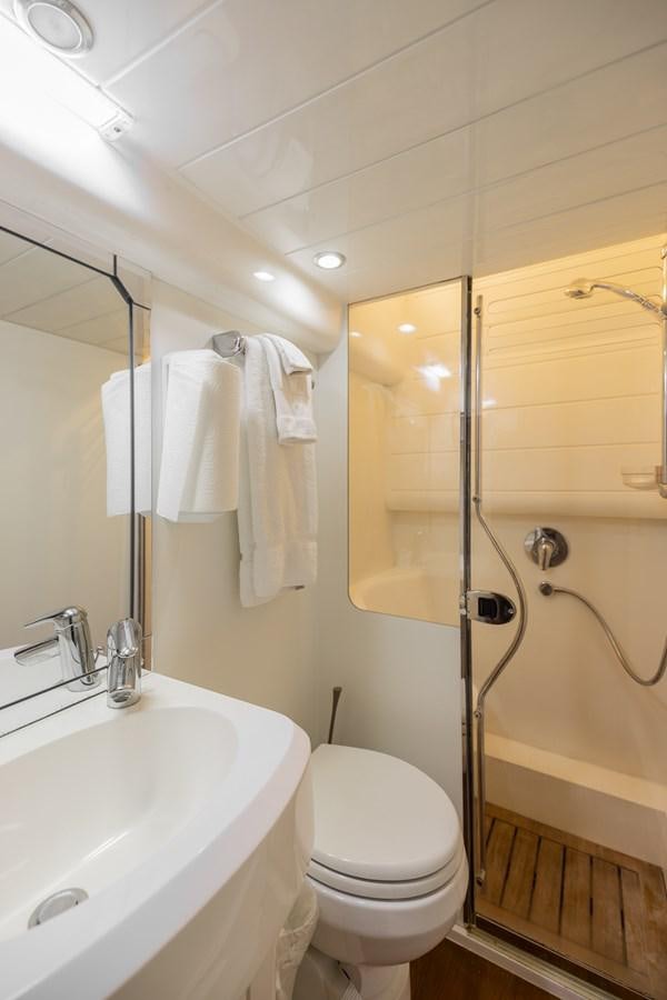 a bathroom with a toilet and sink aboard ODYSSEA Yacht for Sale