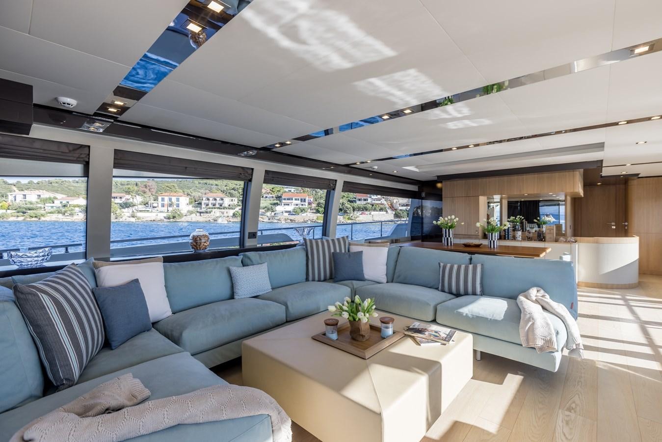 a living room with a large window aboard KATARIINA XO Yacht for Charter