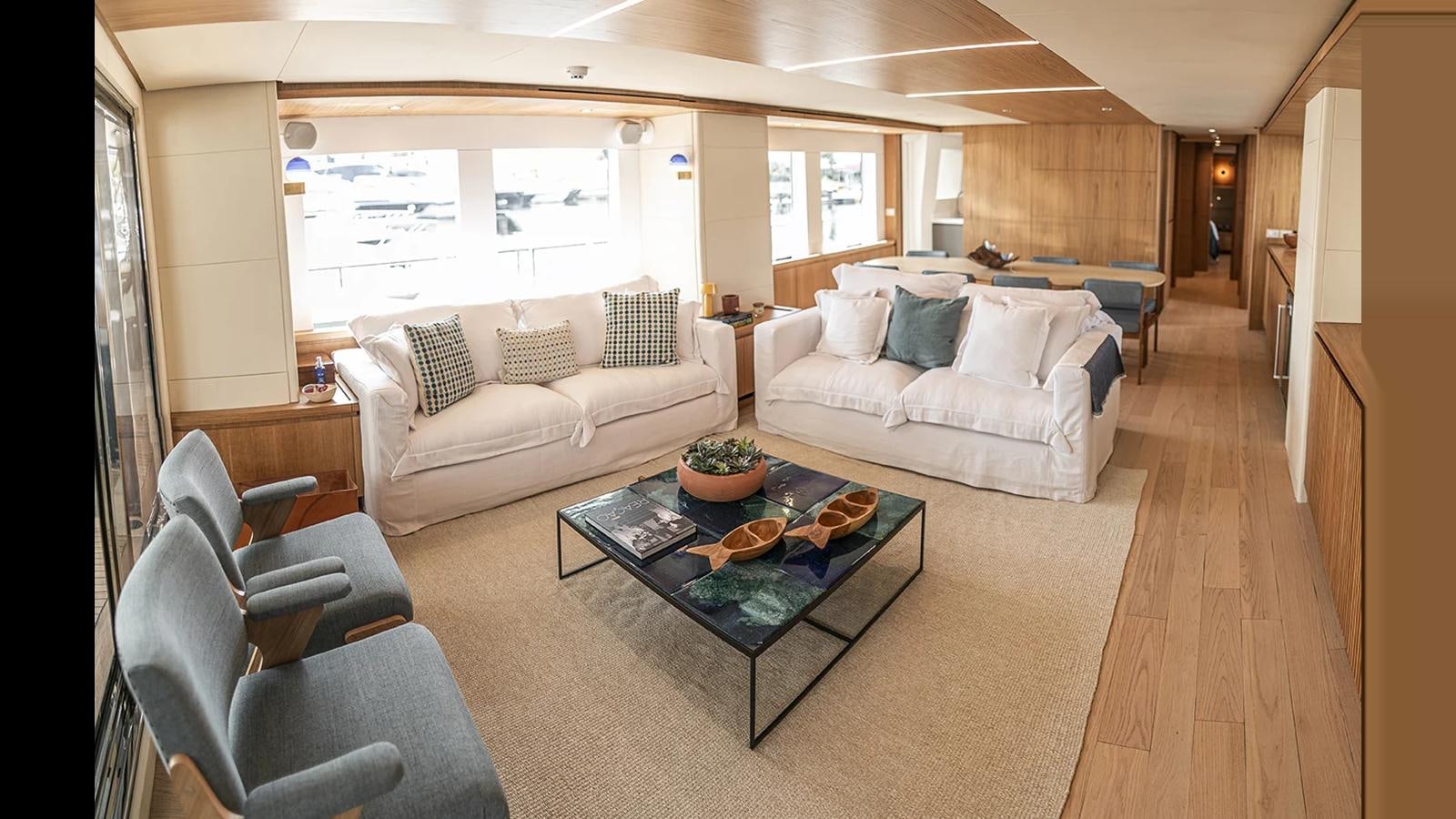 a living room with a couch and a coffee table aboard 2024 INACE EXPLORA 115 Yacht for Sale