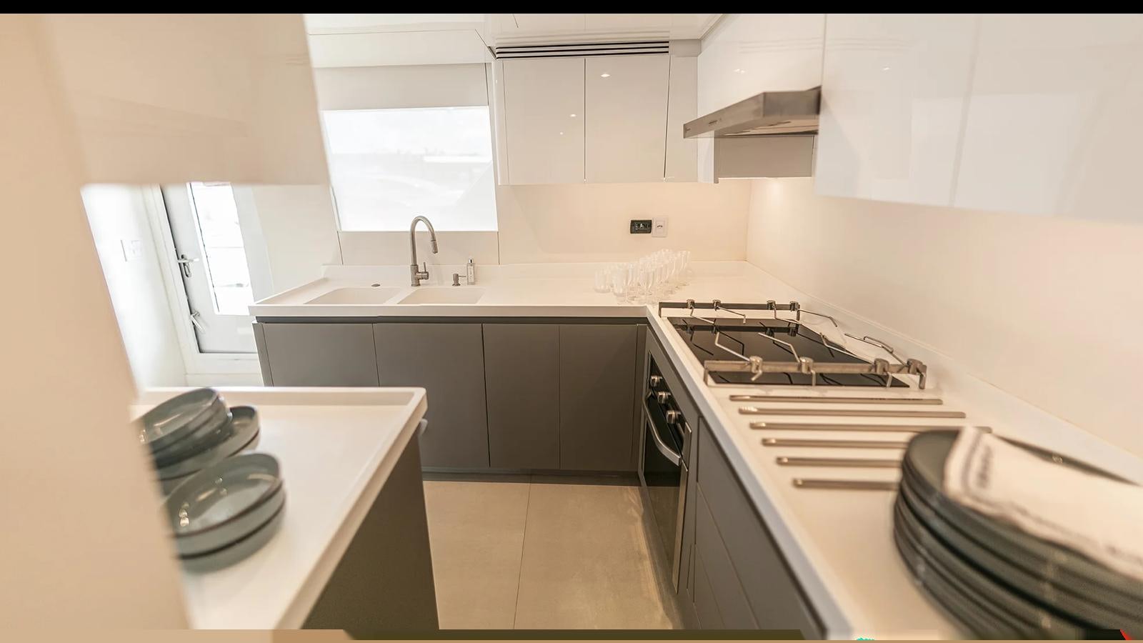 a kitchen with white cabinets aboard 2024 INACE EXPLORA 115 Yacht for Sale