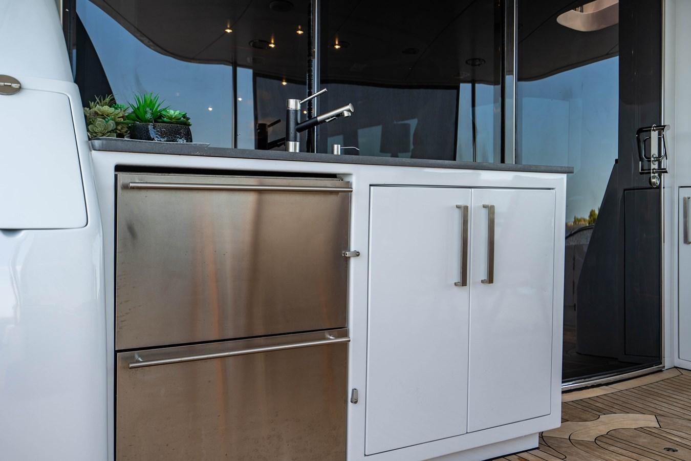 a refrigerator next to a door aboard VOYAGER Yacht for Sale