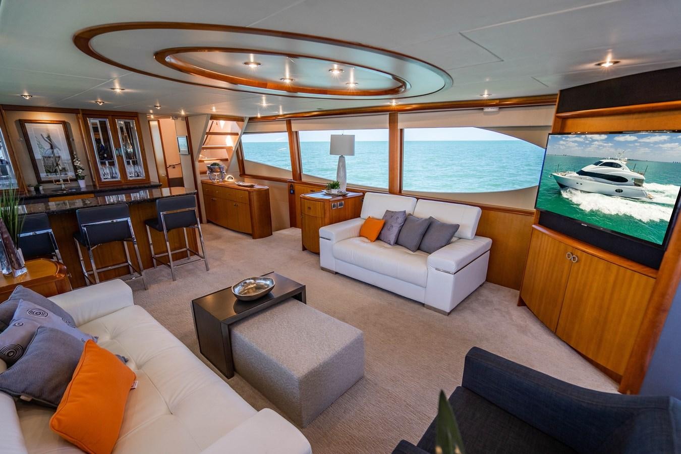 a living room with a large pool table and couches aboard VOYAGER Yacht for Sale