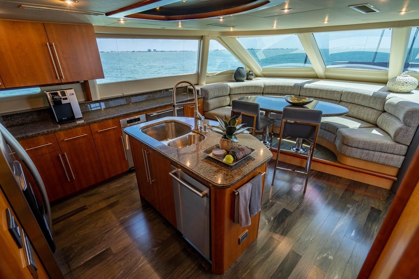 a kitchen with a table and a couch aboard VOYAGER Yacht for Sale