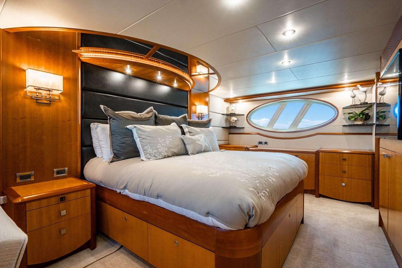 a bed with a white bed spread aboard VOYAGER Yacht for Sale