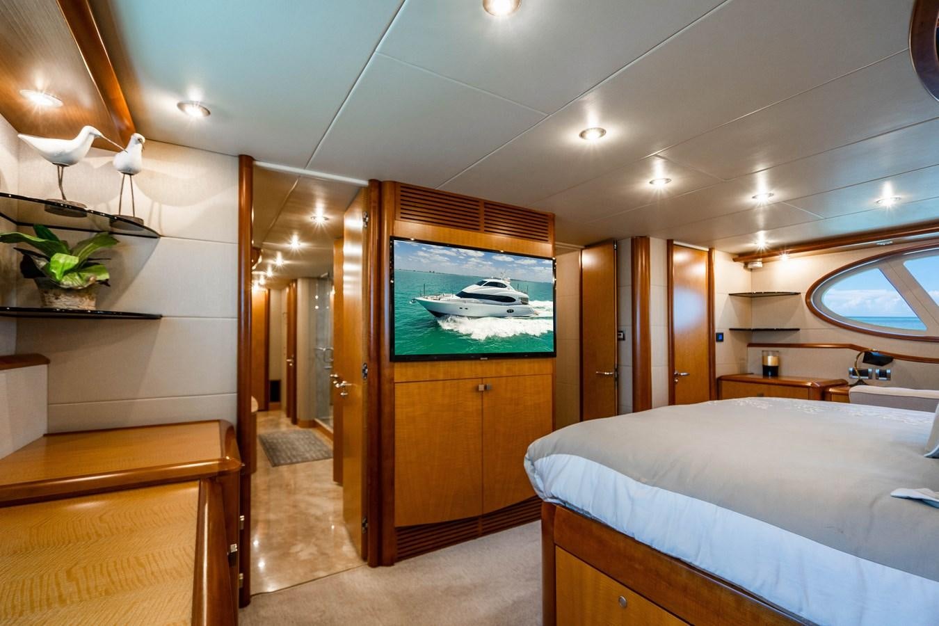a room with a bed and a door aboard VOYAGER Yacht for Sale