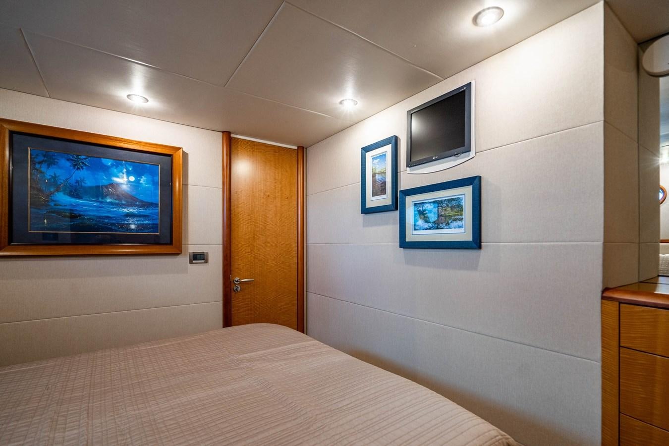 a bedroom with a bed and tv aboard VOYAGER Yacht for Sale