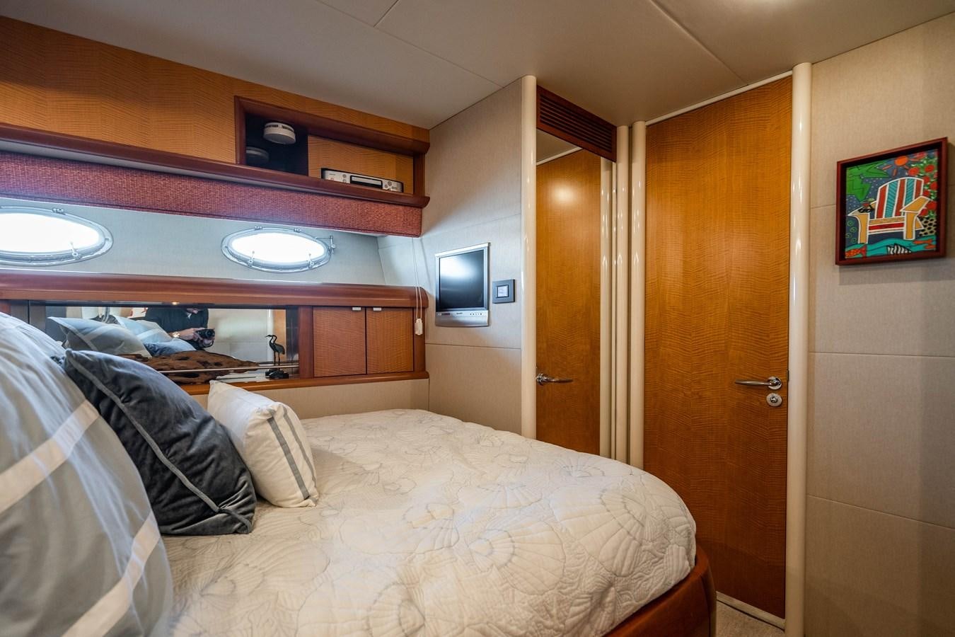 a bedroom with a bed and a television aboard VOYAGER Yacht for Sale
